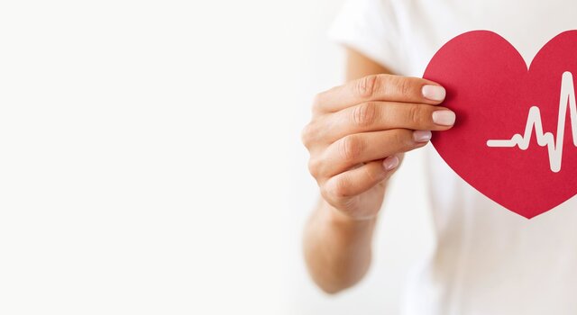 front_view_woman_holding_paper_heart_with_heartbeat__1_